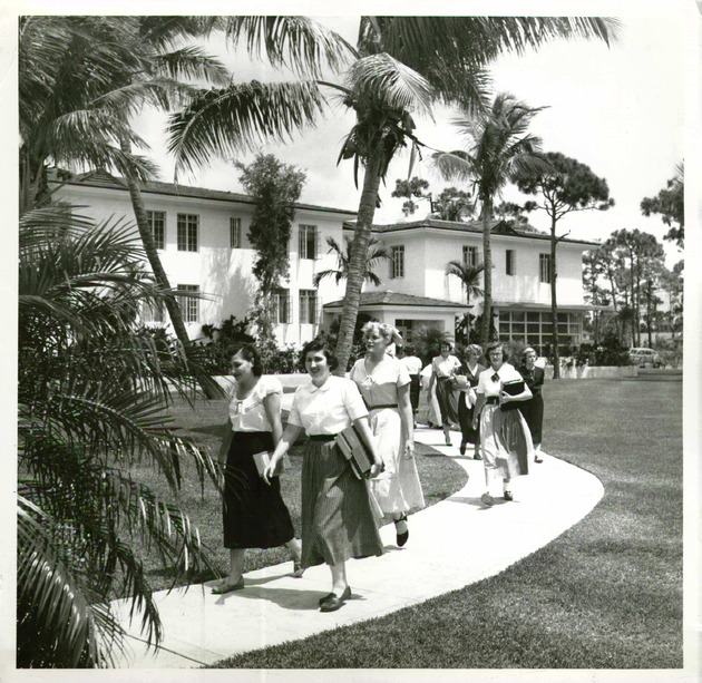 Students walking by Kelley House